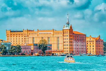 A view of the island of Giudecca, located opposite main island Venice.  Building of Hilton Molino Stucky Venice.Italy. - obrazy, fototapety, plakaty