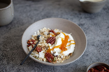 fresh oak granola with pecan nuts on concrete background