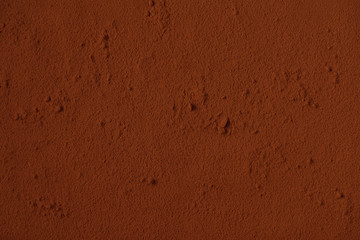 Table surface covered with cocoa powder. Background. Space for text. Copy space.