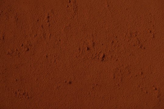 Table surface covered with cocoa powder. Background. Space for text. Copy space.