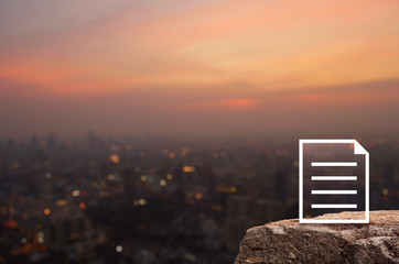 Document flat icon on rock mountain over blur of cityscape on warm light sundown, Technology communication concept