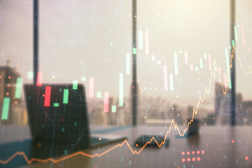 Abstract creative financial graph with world map and modern desktop with pc on background, financial and trading concept. Multiexposure