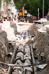 Repair of the heating main. Construction works. An open section of the roadway in the city in the summer for the repair of the heating main of centralized heating of houses