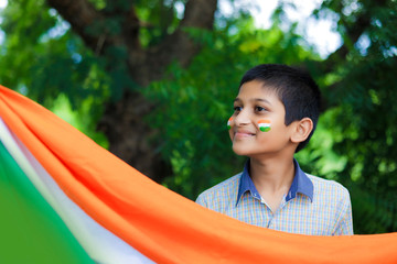young indian child with indian flag on face