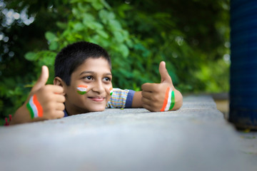 young indian child with indian flag on face