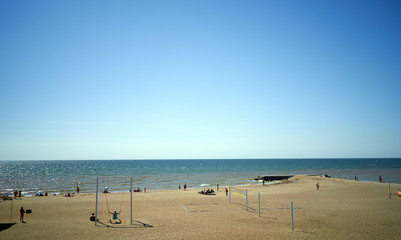 people sunbathe by the sea