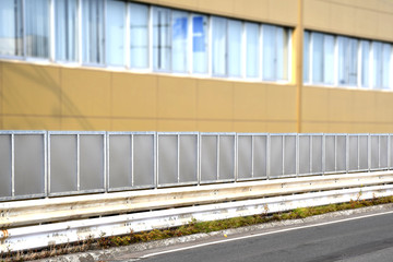 Noise barrier on the road in resident area, sound wall, sound berm or acoustical barrier, exterior...