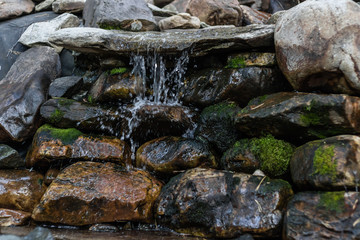 artificial mini waterfall on stones