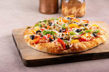 Delicious vegetable pizza on wooden board