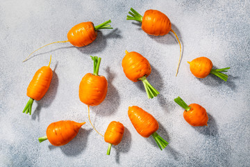  Short Rondo carrots on grey textured background,  top view