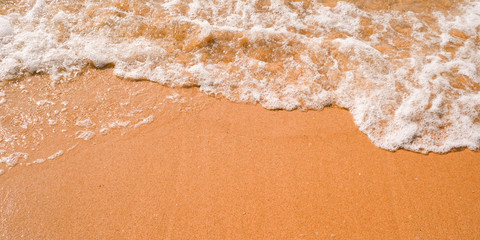 Fototapeta na wymiar Tourist travel banner design template, copy space. White foam of a sea wave, golden sand beach, turquoise ocean water.