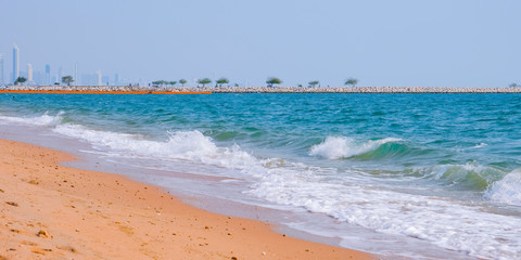 Caribbean beach with golden sand, emerald water and blue sky with clouds. Empty beach. Copy space banner.