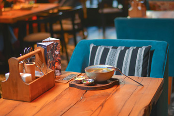 A bowl of delicious vegetable soup on a beautifully set table. Eating out. Restaurant concept.