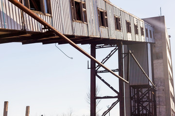 Old, abandoned concrete plant with iron rusty tanks and metal structures. The crisis, the fall of the economy, stop production capacity led to the collapse. Global catastrophe.