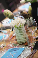 Gala dinner setup with white flowers and blue place cards.