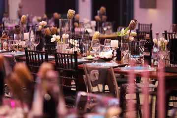 Gala dinner setup with white flowers and blue place cards.