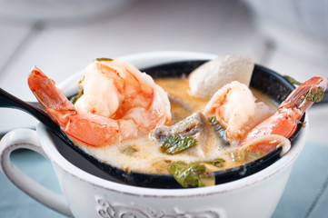 Spicy Thai soup Tom kha with coconut, bok choy and prawns