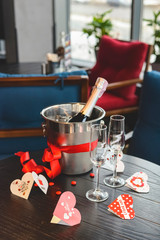 Romantic still life with bottle of champagne in ice bucket and two champagne glasses. Valentines day.