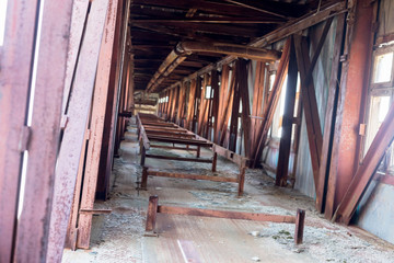 Rusted metal structures in the old mine. The crisis, the fall of the economy. Global catastrophe. Old photo effect