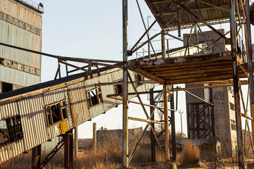 Old, abandoned concrete plant with iron rusty tanks and metal structures. The crisis, the fall of the economy, stop production capacity led to the collapse. Global catastrophe.