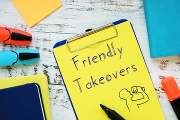 Business concept meaning Friendly Takeovers with sign on the piece of paper.