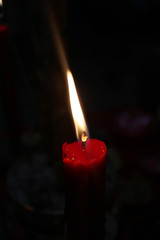 Red candle isolated on black background 