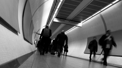 Commuters walking through access tunnels in London