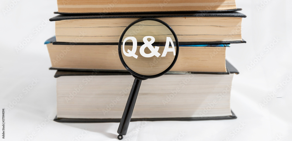 Poster q and a text inscription on magnifying loup with stack or bunch of books on white background, search