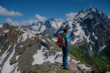 Woman hiker on a top of a mountain