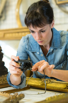 portrait of woman renovating picture frame