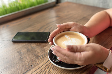 woman holding a cup of coffee. cup of coffee