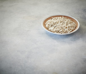 nuts in the plate and up concept, marble grey background.
