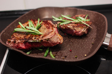 grilled beef steak with vegetables, seasoned with pepper and rosemary, close-up