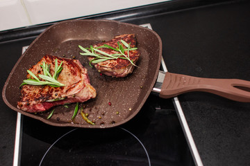 grilled beef steak with vegetables, seasoned with pepper and rosemary, close-up
