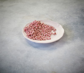 nuts in the plate and up concept, marble grey background.