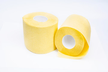Yellow toilet paper rolls isolated on white background