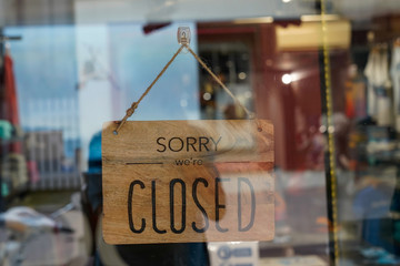 wooden sorry we are closed sign board wood on windows shop restaurant cafe store signboard