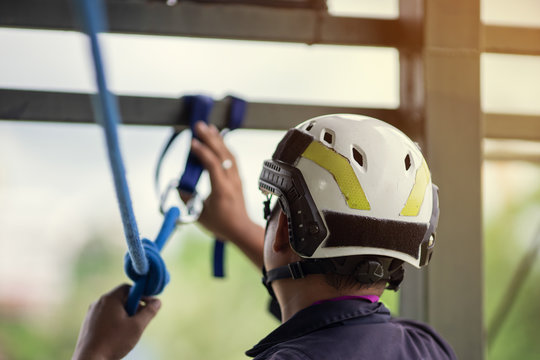 Training rescue emergency accident, Man wearing helmet accessories for training high building rescue using ropes. - Powered by Adobe