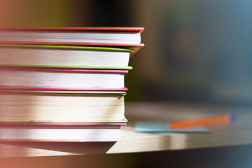 Close-up of a stack of books. The concept of home reading of paper books, school education and...