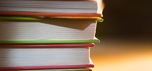 Close-up of a stack of books. The concept of home reading of paper books, school education and Institute, back to school. Space for text, background.