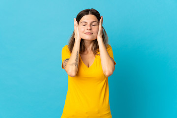 Young slovak woman isolated on blue background frustrated and covering ears