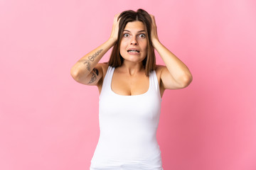 Young slovak woman isolated on pink background doing nervous gesture