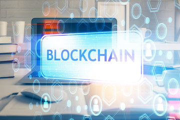 Multi exposure of blockchain theme hologram and table with computer background. Concept of bitcoin...