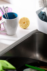 Dirty coffee mug on a domestic kitchen with lemon slice