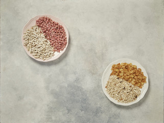 nuts in the plate and up concept, marble grey background.