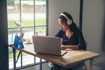 Businesswoman working online at the home office via laptop. Asian young entrepreneur watching webinars and talking during meeting video conference calls with team. 