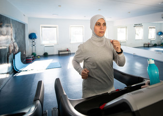 Middle Eastern Woman Running on Treadmill