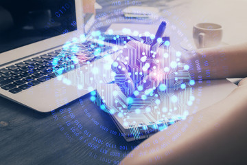 Multi exposure of writing hand on background with brain hologram. Concept of learning.