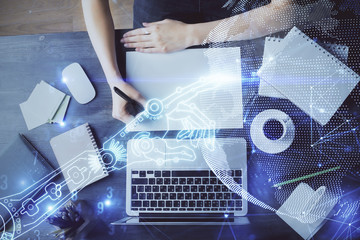 Tech theme hologram over woman's hands taking notes background. Concept of hightech. Double exposure