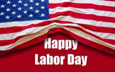 Fototapeta na wymiar Happy Labor Day text and USA flag on red color background